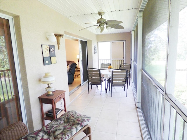 sunroom with wood ceiling, ceiling fan, and a healthy amount of sunlight