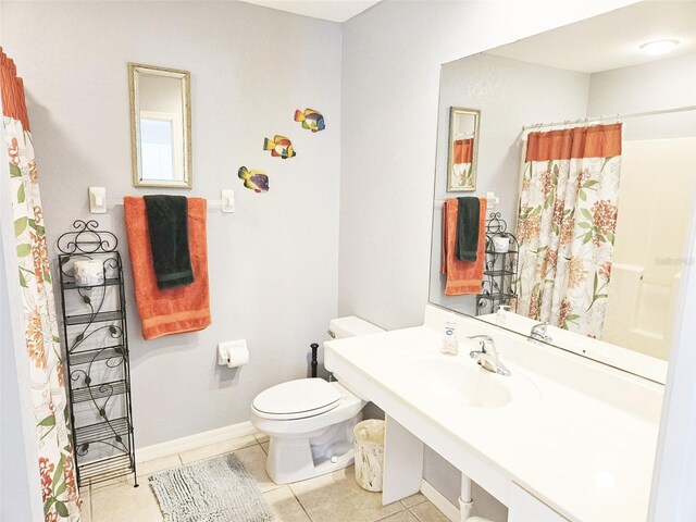 bathroom featuring tile patterned flooring, toilet, sink, and a shower with shower curtain