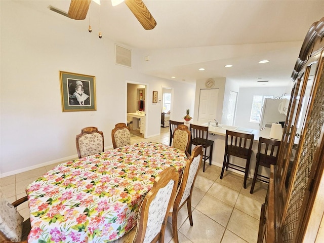 dining area with ceiling fan and light tile patterned flooring