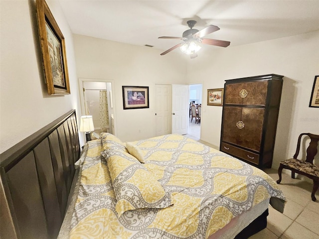 tiled bedroom with ensuite bath and ceiling fan