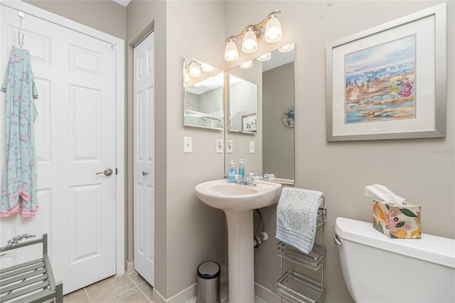 bathroom featuring tile patterned floors, toilet, and sink