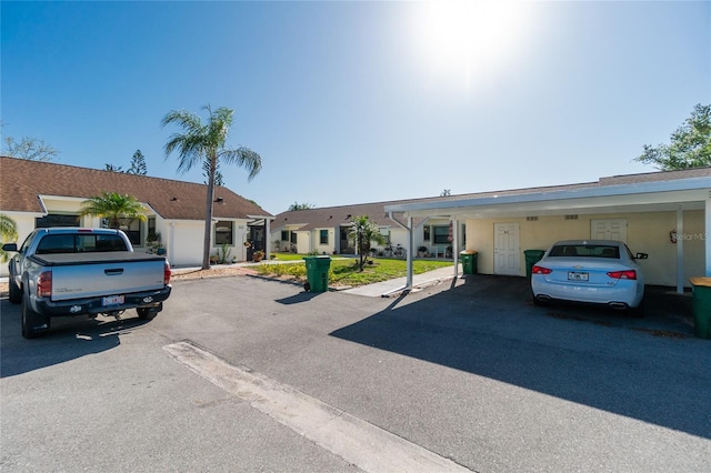 ranch-style home featuring a carport