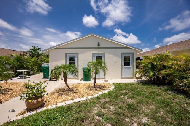 view of front of property with a patio area and a front yard