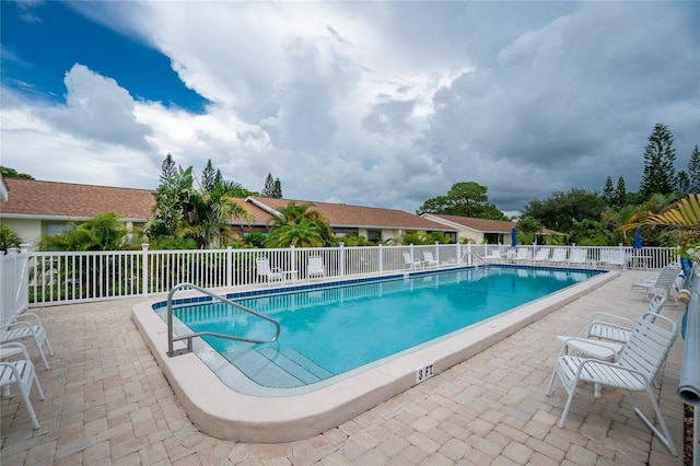 view of swimming pool featuring a patio area