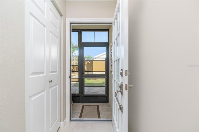 doorway with light tile patterned floors