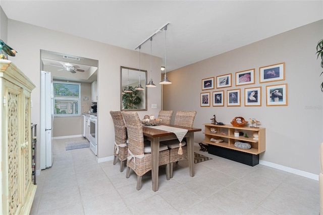 dining area with track lighting and ceiling fan