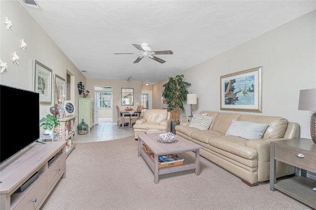 carpeted living room with ceiling fan