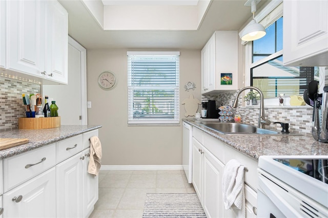 kitchen featuring white cabinets, decorative backsplash, light tile patterned flooring, and sink