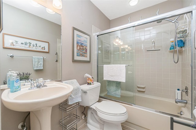 bathroom featuring enclosed tub / shower combo and toilet