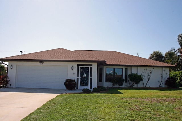 ranch-style home featuring a garage and a front lawn