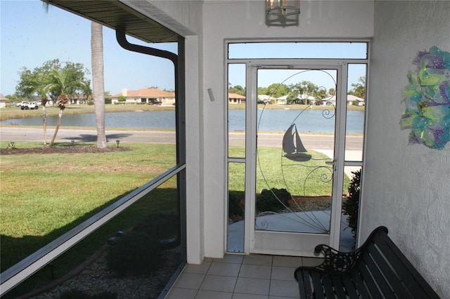 entryway with a water view and light tile patterned floors