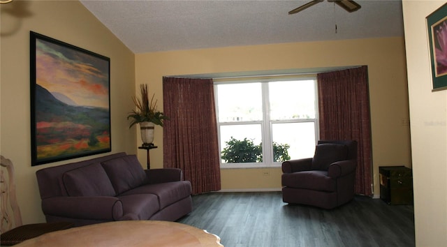 living room featuring ceiling fan, dark hardwood / wood-style floors, and vaulted ceiling