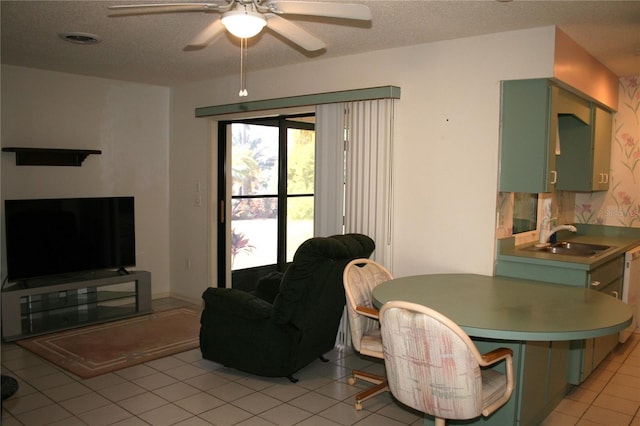 dining space featuring ceiling fan, sink, and light tile patterned floors