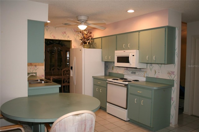 kitchen featuring ceiling fan, sink, a textured ceiling, white appliances, and light tile patterned flooring