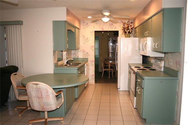 kitchen featuring sink, electric range, ceiling fan, a textured ceiling, and light tile patterned flooring