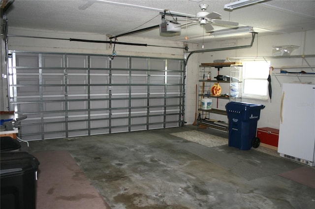 garage featuring white refrigerator, a garage door opener, and ceiling fan