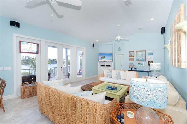 tiled living room featuring ceiling fan, french doors, and lofted ceiling