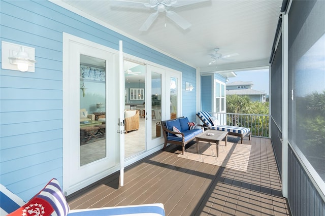 sunroom featuring ceiling fan and french doors