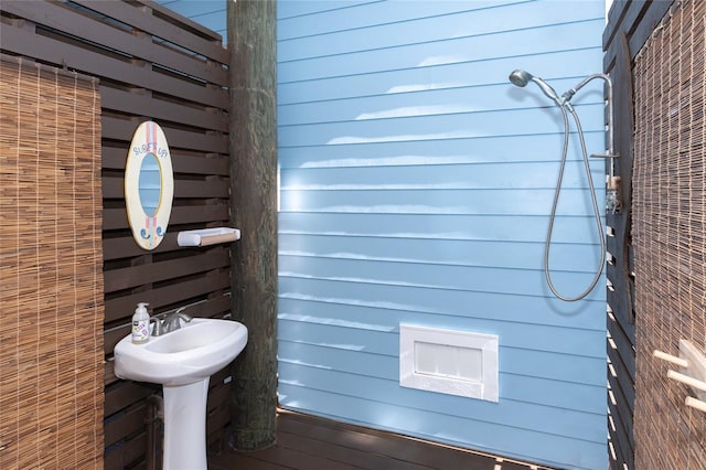 bathroom featuring wooden walls