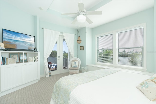 bedroom with ceiling fan, multiple windows, access to exterior, and light carpet