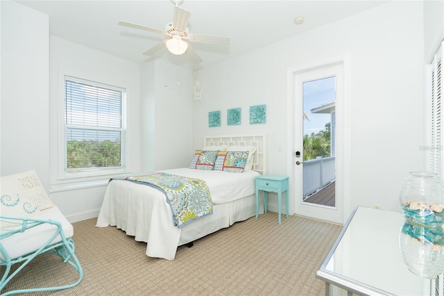 bedroom with ceiling fan, light colored carpet, and multiple windows