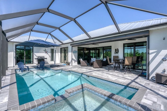 view of swimming pool featuring an in ground hot tub, glass enclosure, and a patio