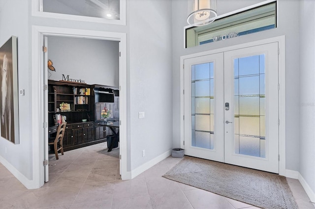 entrance foyer with light tile floors and french doors