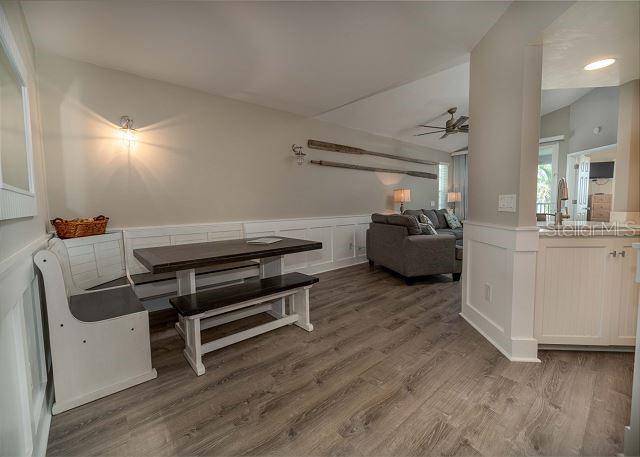 dining area with vaulted ceiling, ceiling fan, and hardwood / wood-style flooring