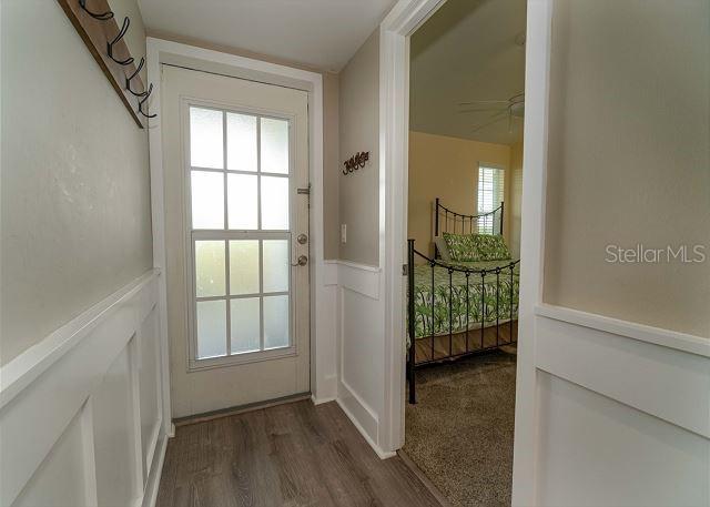 doorway to outside with wood-type flooring