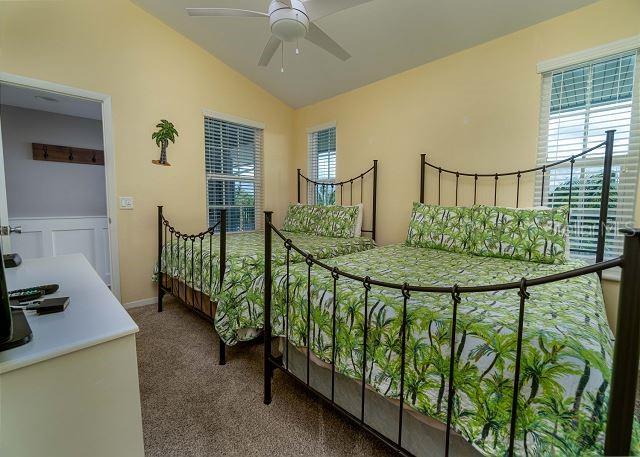 carpeted bedroom featuring lofted ceiling and ceiling fan