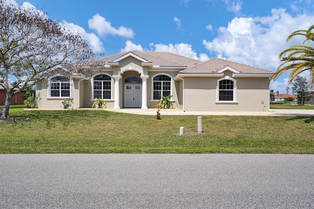 mediterranean / spanish home with a front yard