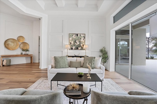 living room with beam ceiling and light wood-type flooring