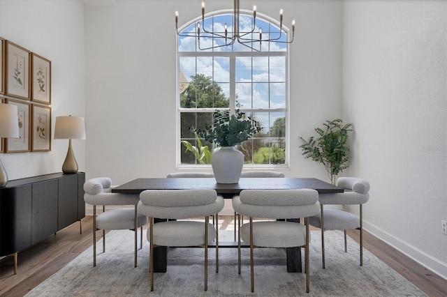 dining area with a notable chandelier and hardwood / wood-style flooring