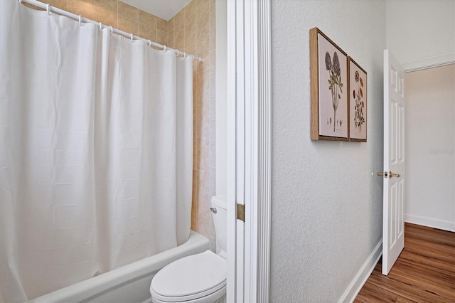 bathroom with shower / bath combination with curtain, toilet, and hardwood / wood-style flooring