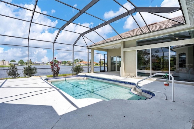 view of pool featuring a patio area, ceiling fan, and glass enclosure