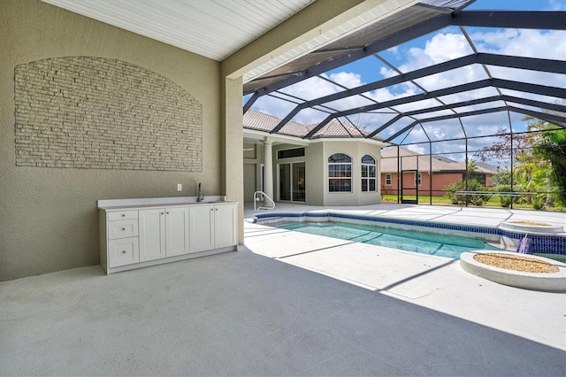 view of pool with a patio area and a lanai