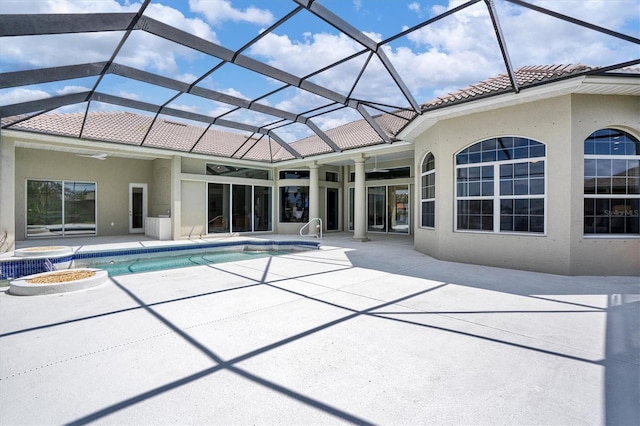 view of pool with a patio area and glass enclosure