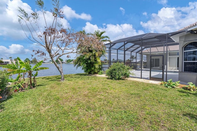 view of yard featuring a water view, a patio area, and glass enclosure