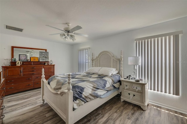 bedroom featuring multiple windows, ceiling fan, and hardwood / wood-style flooring