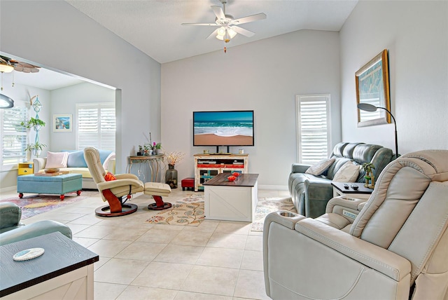 living room with ceiling fan, vaulted ceiling, and light tile flooring