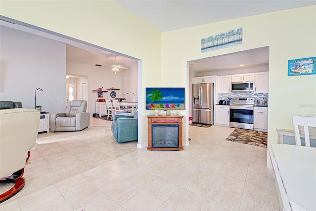 living room featuring ceiling fan and light tile floors