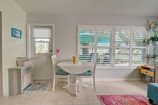 dining space with light tile flooring and a textured ceiling