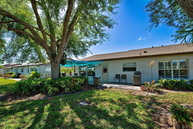 rear view of house with a yard