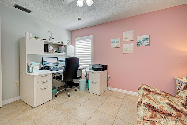 tiled home office featuring a textured ceiling and ceiling fan