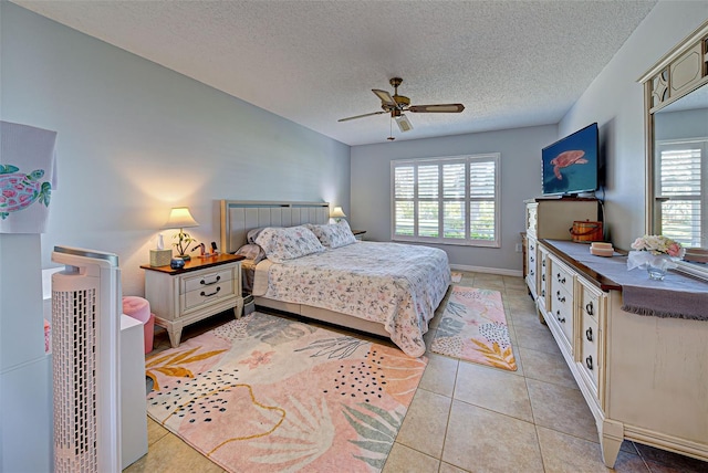 tiled bedroom featuring ceiling fan and a textured ceiling