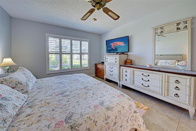 tiled bedroom featuring a textured ceiling and ceiling fan