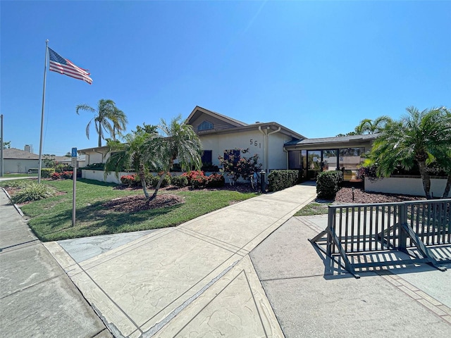 ranch-style home with a front lawn