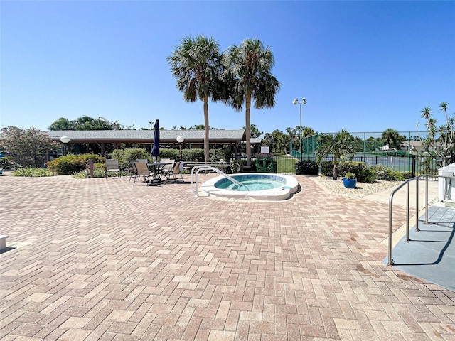 view of swimming pool with a patio and a hot tub