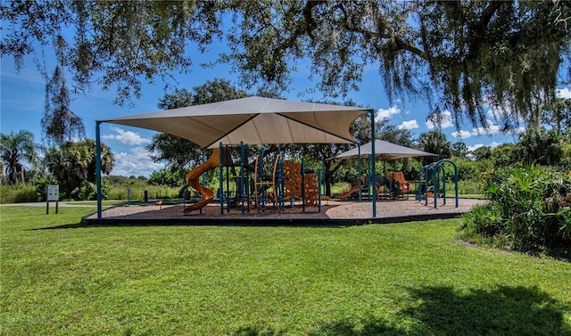 community jungle gym featuring a yard