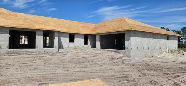 exterior space featuring an attached garage and concrete block siding